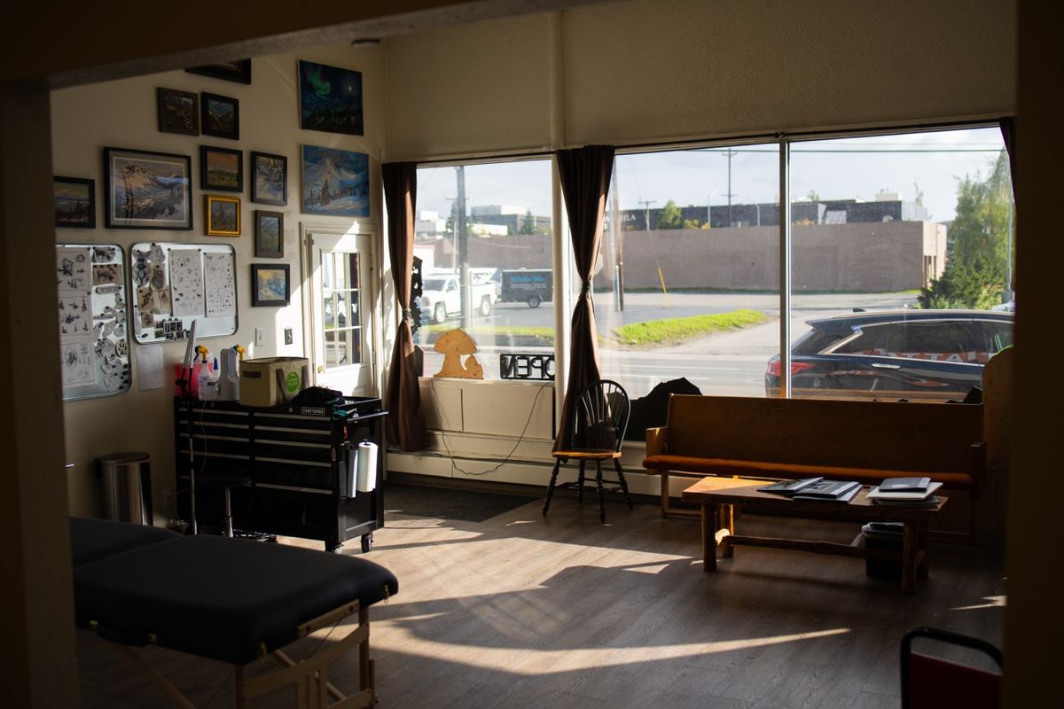 AK Tattoo Anchorage interior multiple artists working — professional tattoo studio Alaska