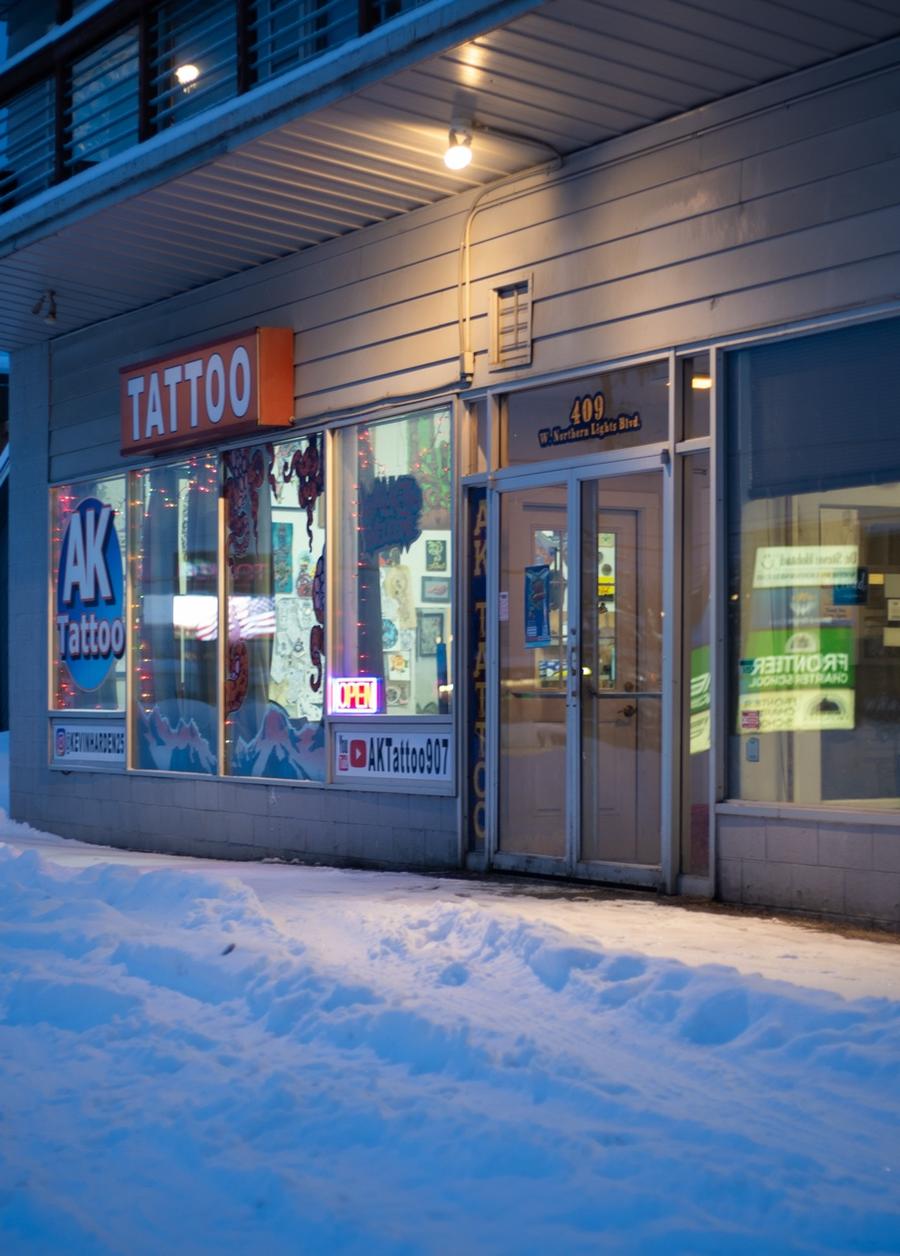 AK Tattoo Anchorage open sign at night — 409 W Northern Lights Blvd tattoo shop Alaska