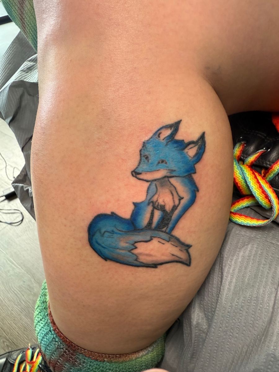 Blue fox color tattoo on thigh — Cade Bennett, color tattoo artist AK Tattoo Anchorage Alaska