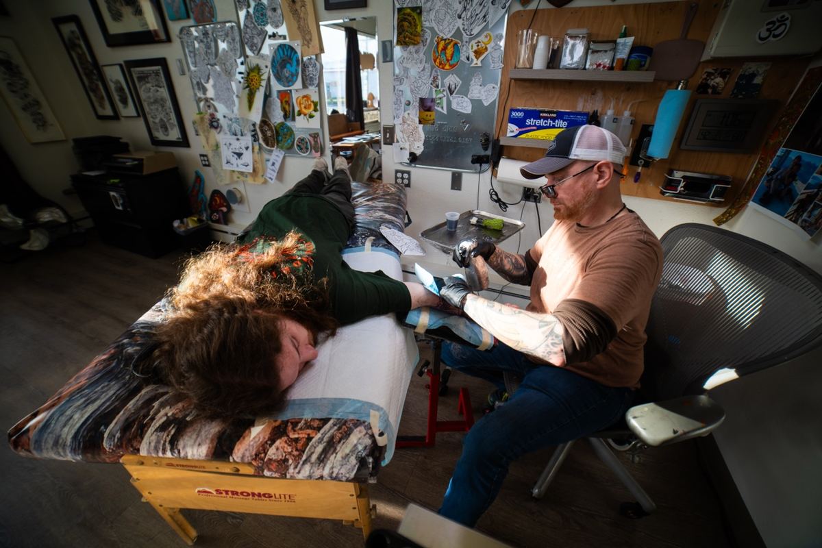 Cade Bennett tattooing at AK Tattoo Anchorage Alaska — professional tattoo in progress