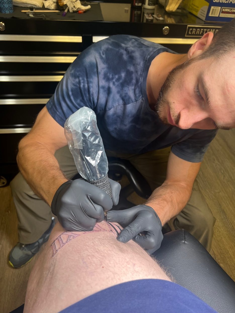 Cade Bennett close up tattooing Anchorage Alaska — AK Tattoo tattoo artist in action